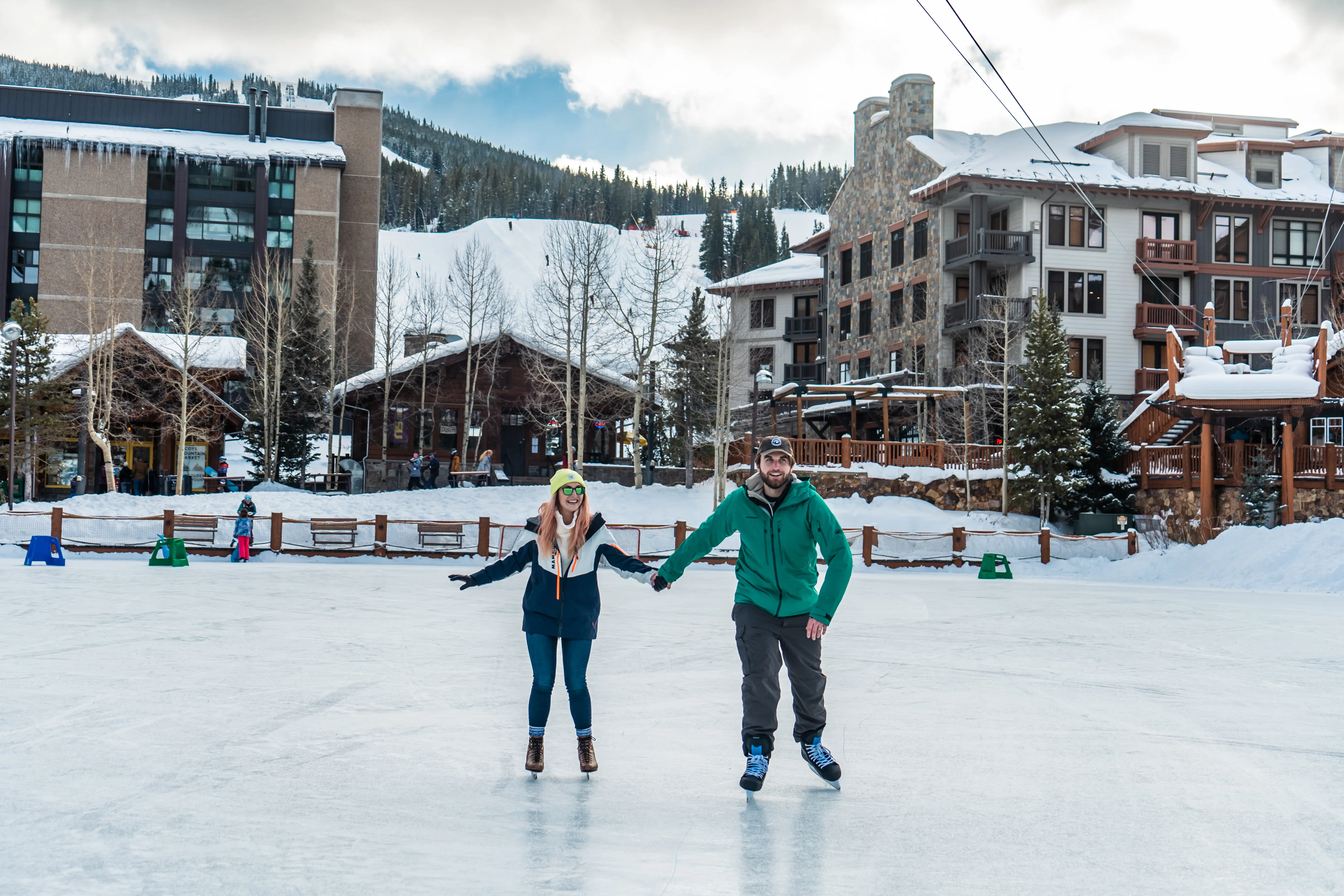 couple holding hands and skating on west lake