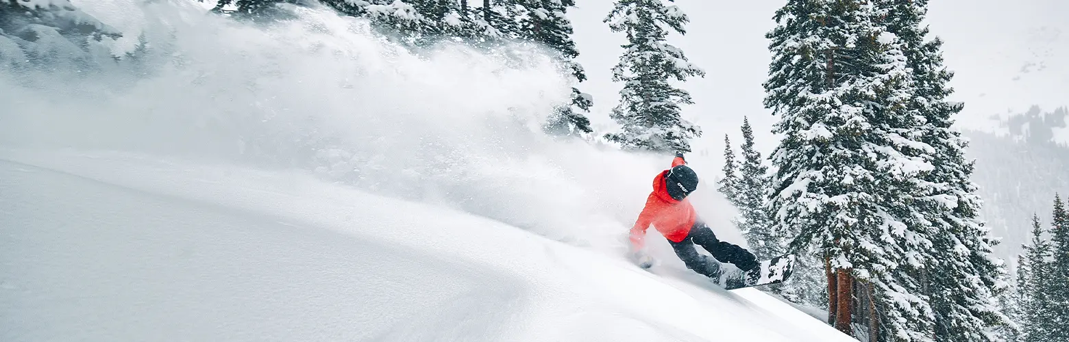 snowboarder slashing powder