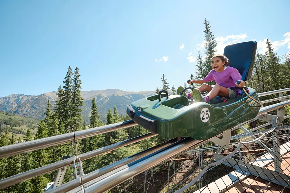 girl on the rocky mountain coaster on a sunny day