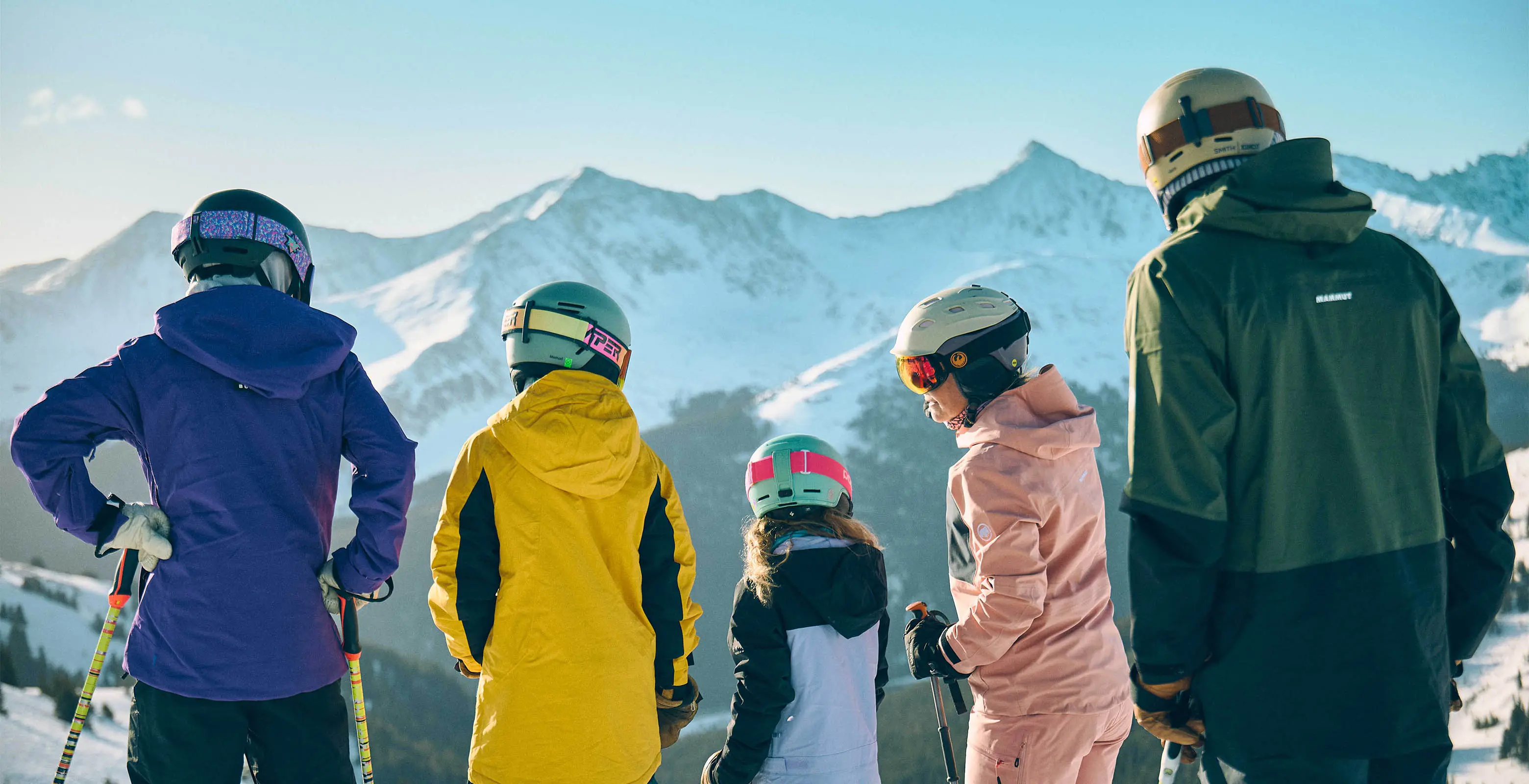 family skiing on a bluebird day