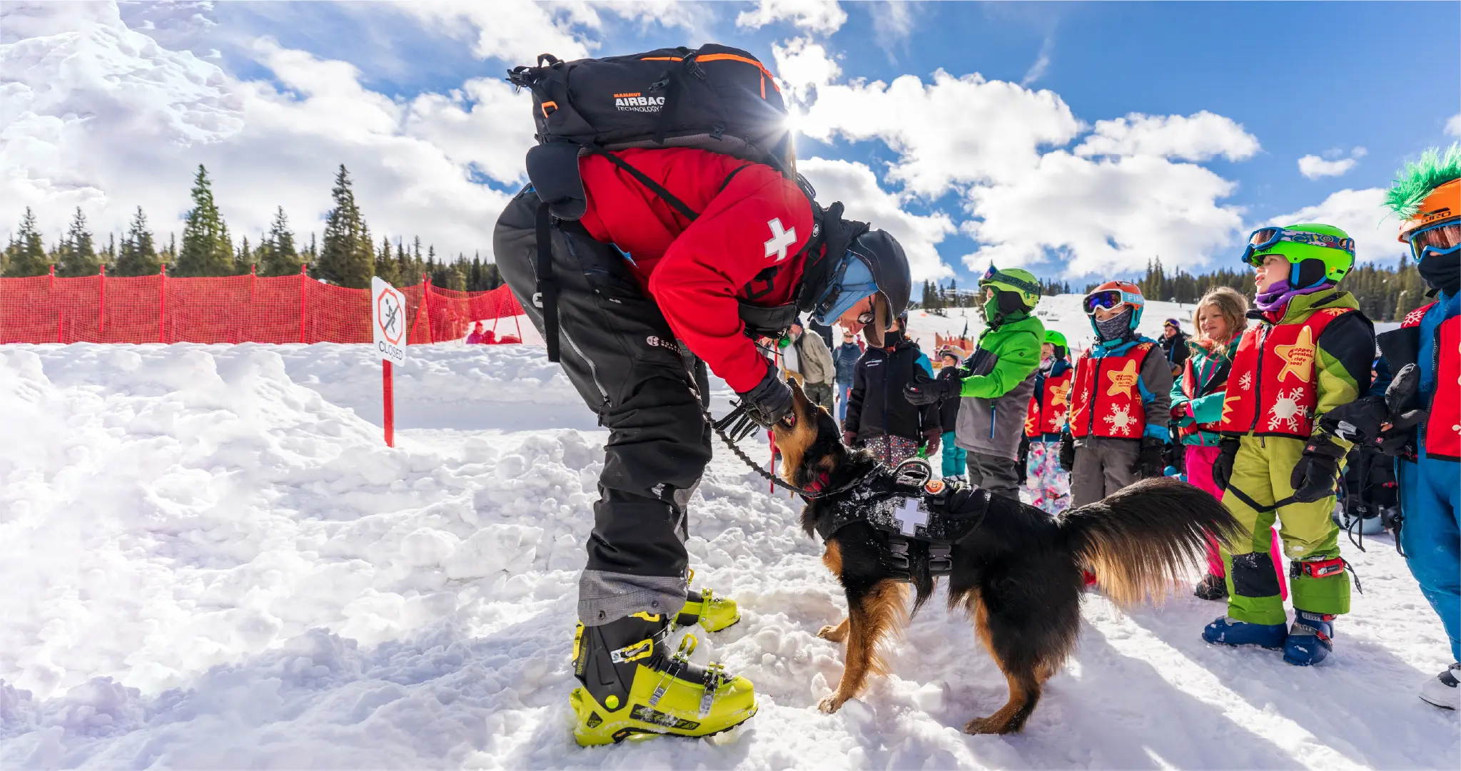 ski patrol with avalanche rescue dog