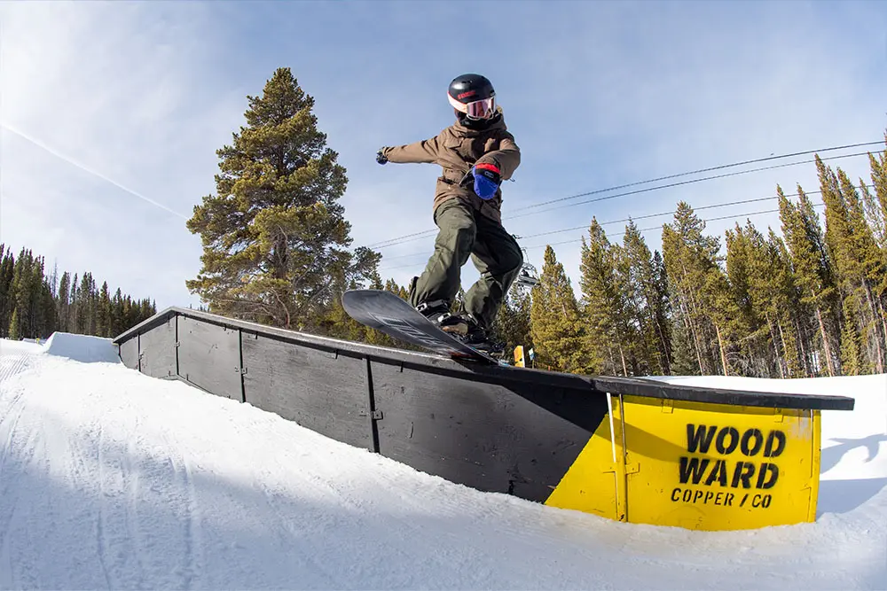 snowboarder hitting a rail at Woodward Copper peace park