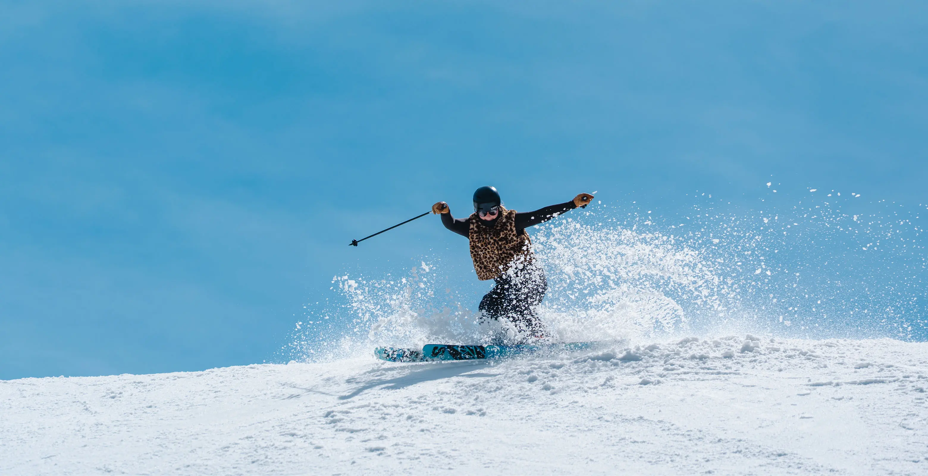 girl skiing in the spring snow on a bluebird day