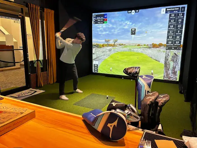 golfing at the hit balls golf simulator in copper center village
