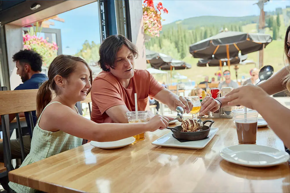 family eating dessert at ten mile tavern in the summer